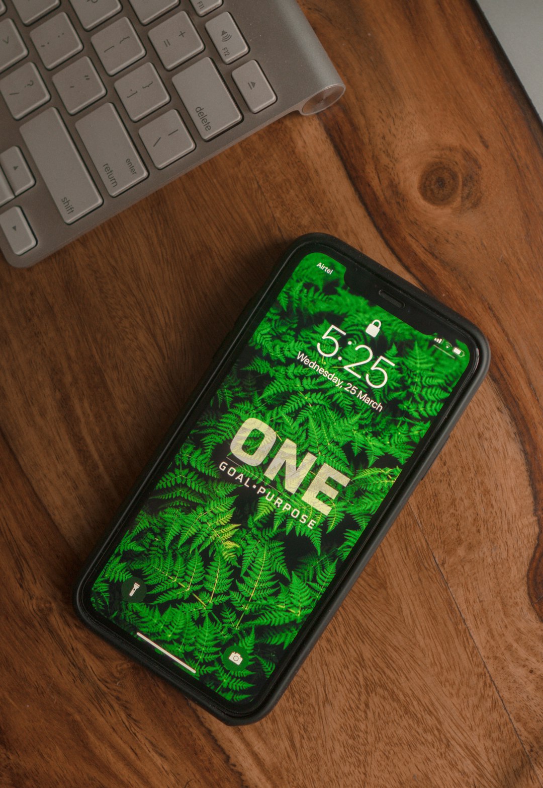 services-01 black-and-green-android-smartphone-on-brown-wooden-table-lhah-x1g5fm